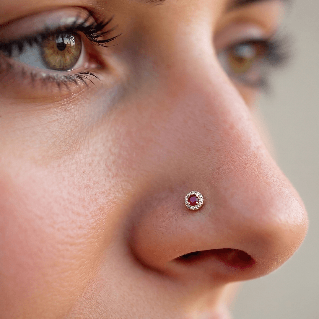 Classic crimson zirconia and diamond halo nose pin in 18k yellow gold