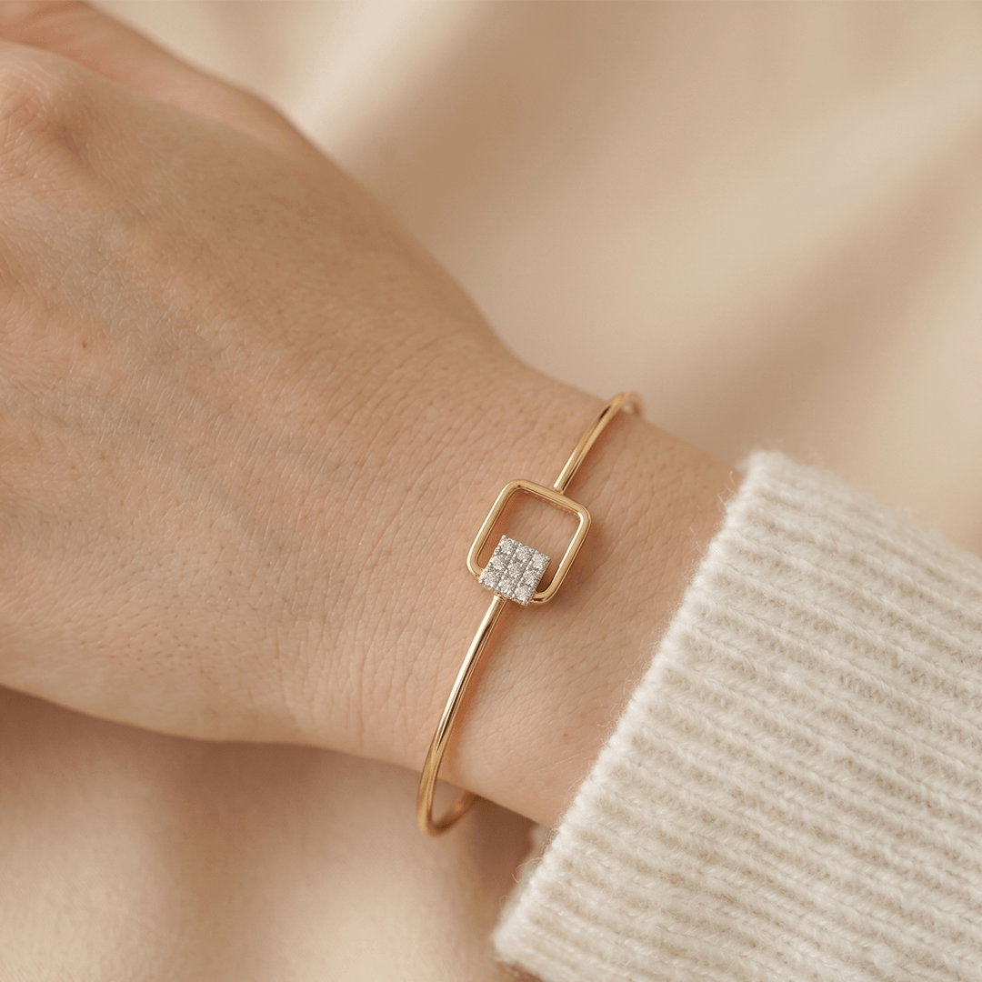 Modern geometric diamond square bypass bangle in 18k yellow gold