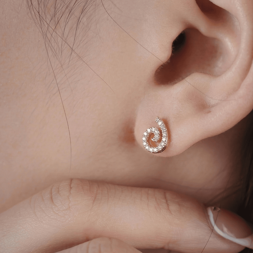 Delicate swirl diamond stud earrings in 18k yellow gold